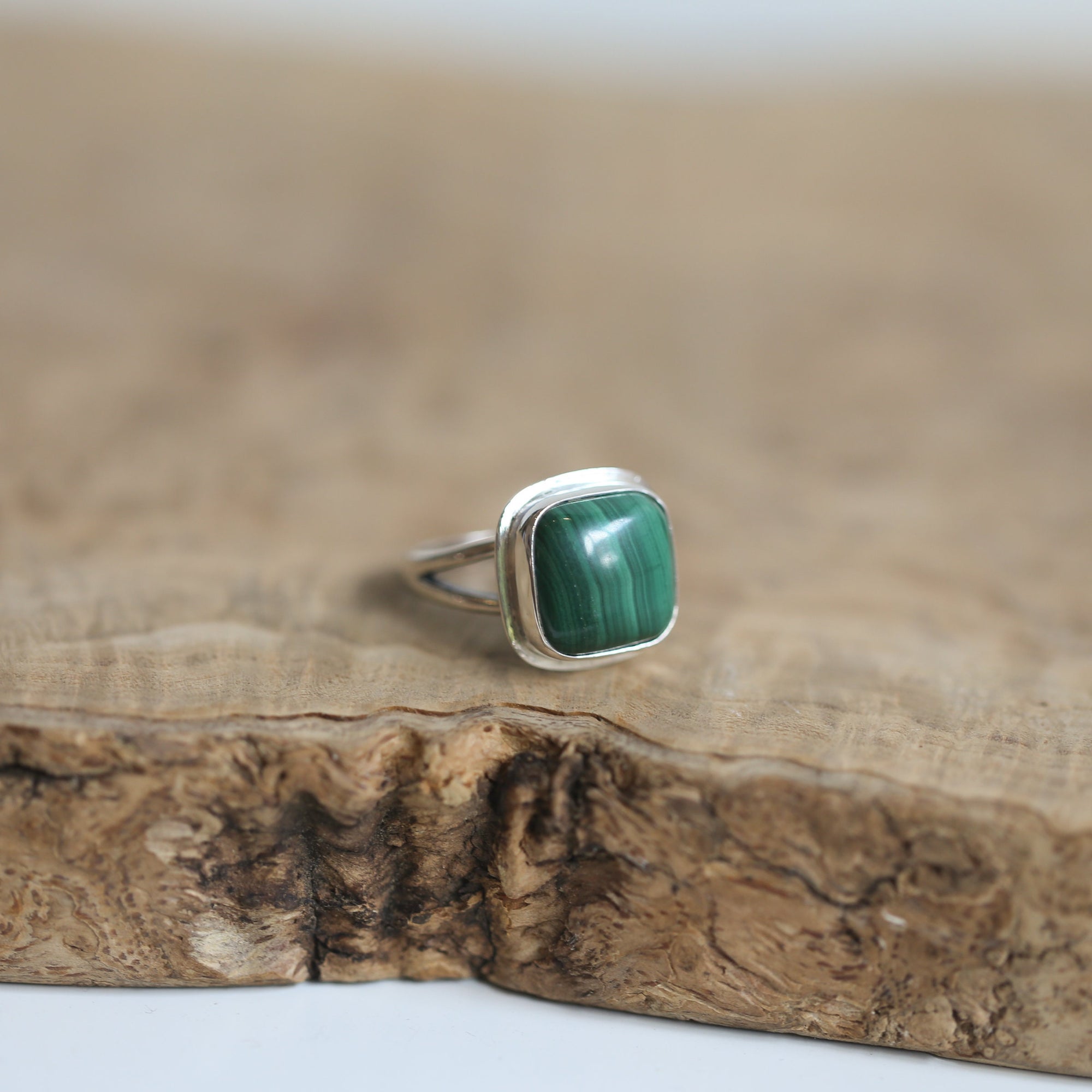 May include: A silver ring with a square green malachite gemstone
