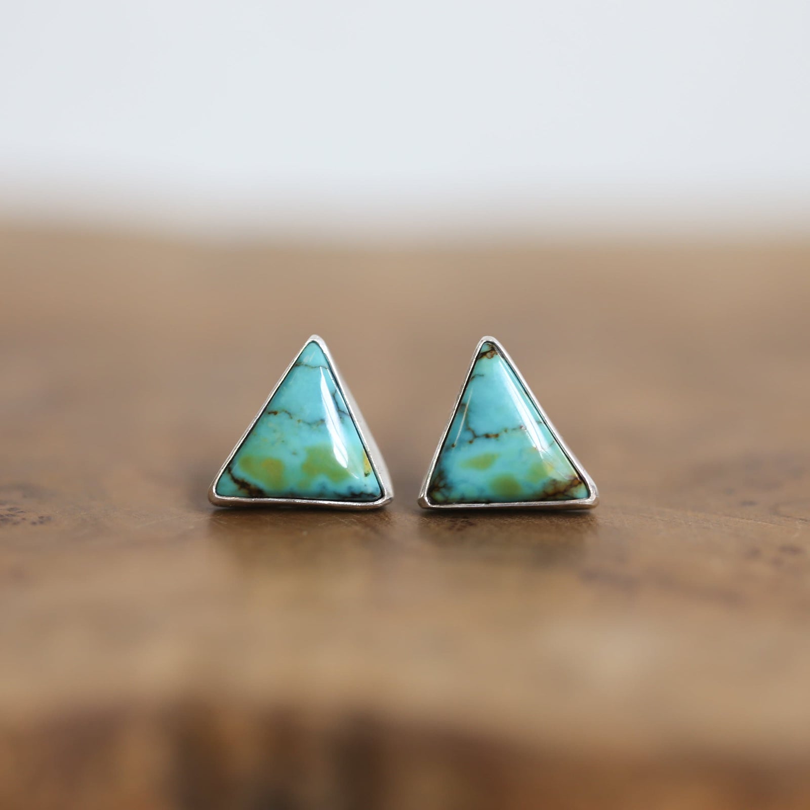 May include: Two triangular turquoise earrings with silver settings